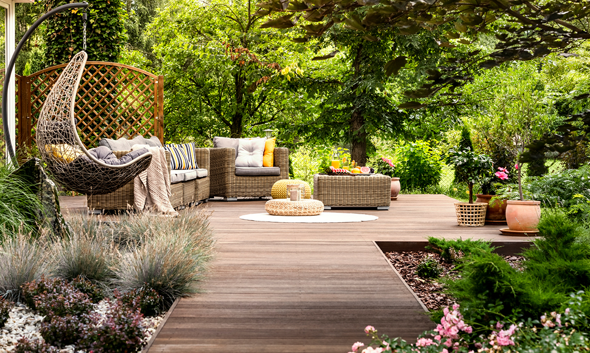 A backyard living space with deck chairs and lots of trees