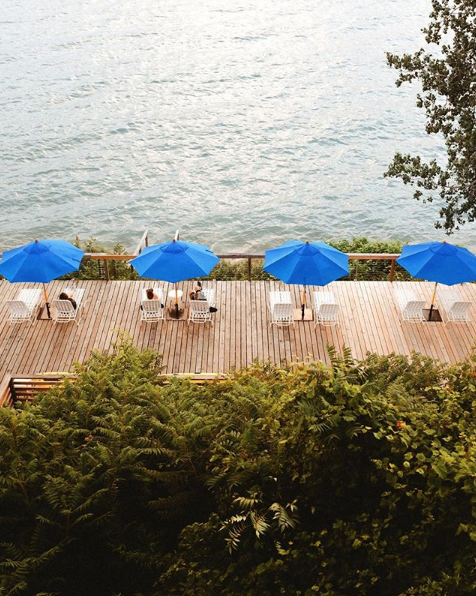 Beach chairs on a dock near a lake