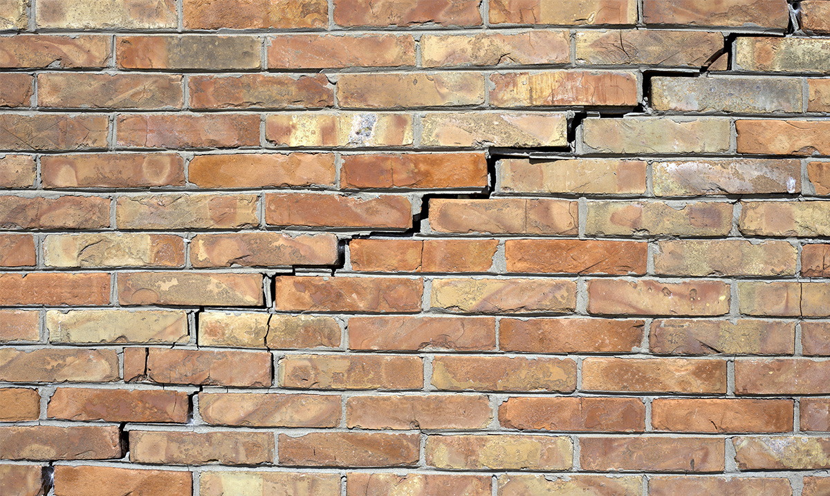 A brick wall with a crack in it