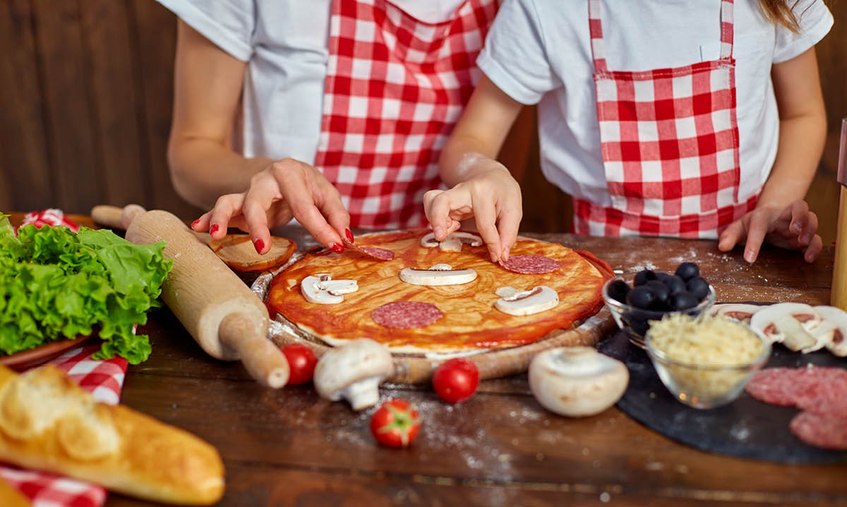 Two people making pizza