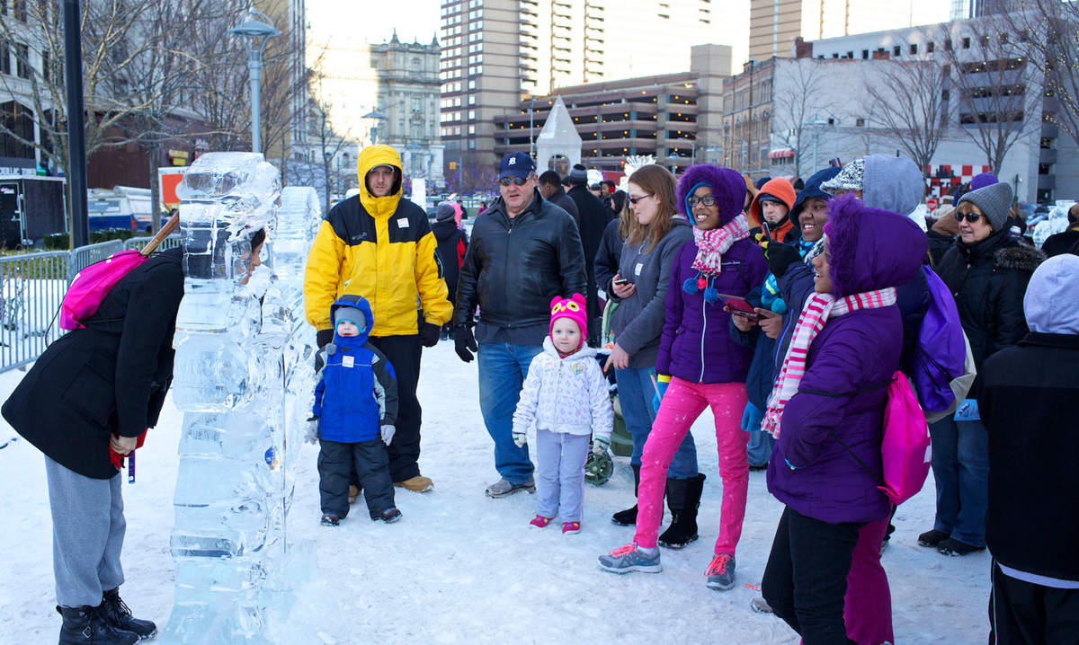 Kids looking at an ice sculpture at Winter Blast