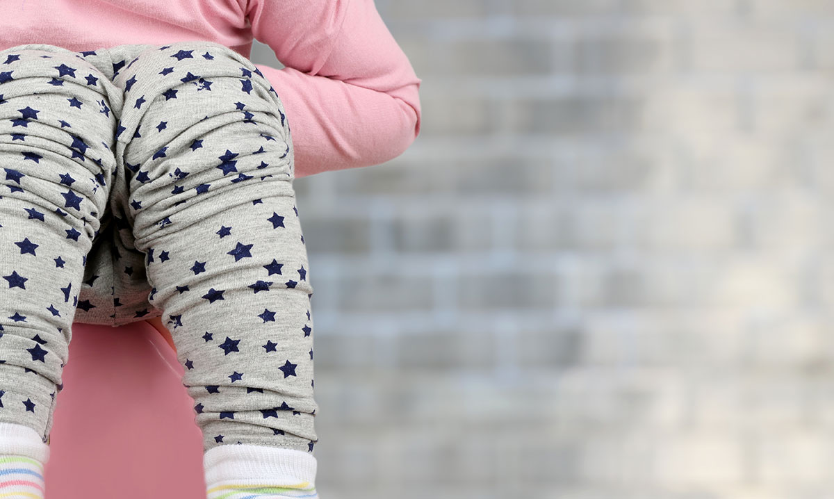 Girl sitting on a child potty