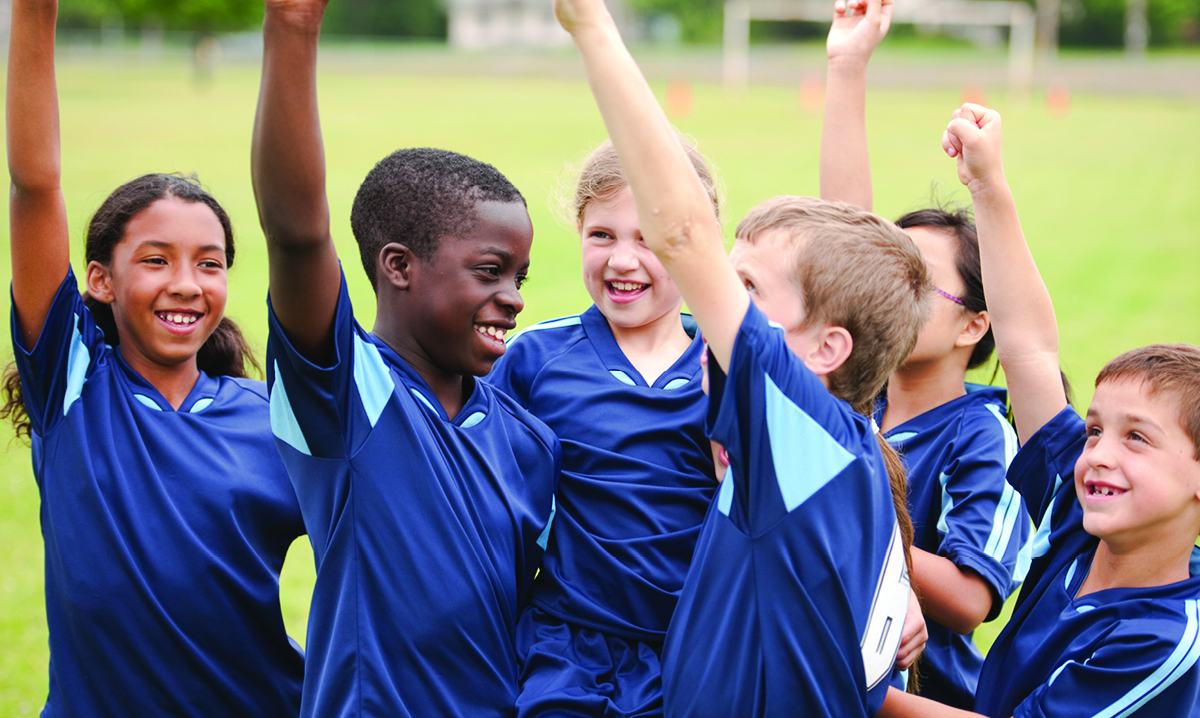 A kids soccer team celebrates