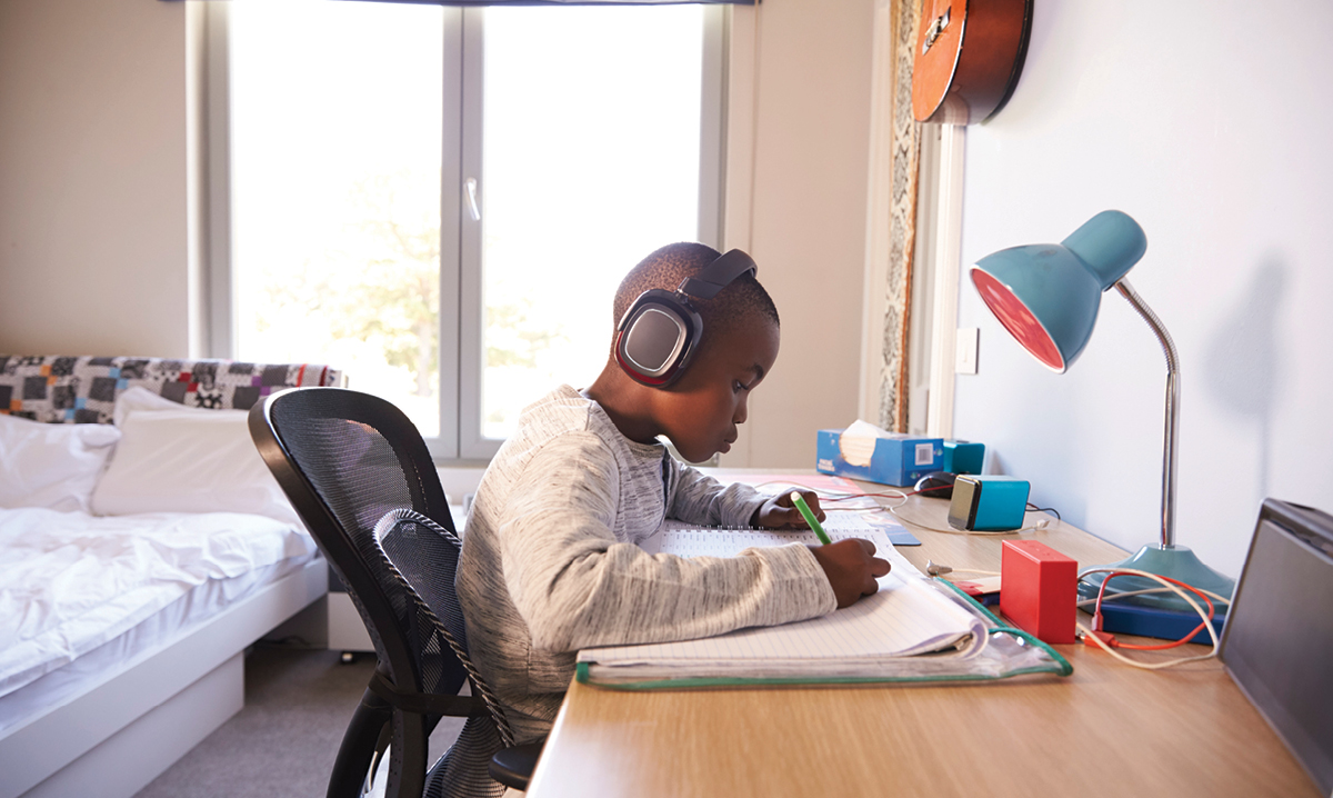Child studying with headphones and music