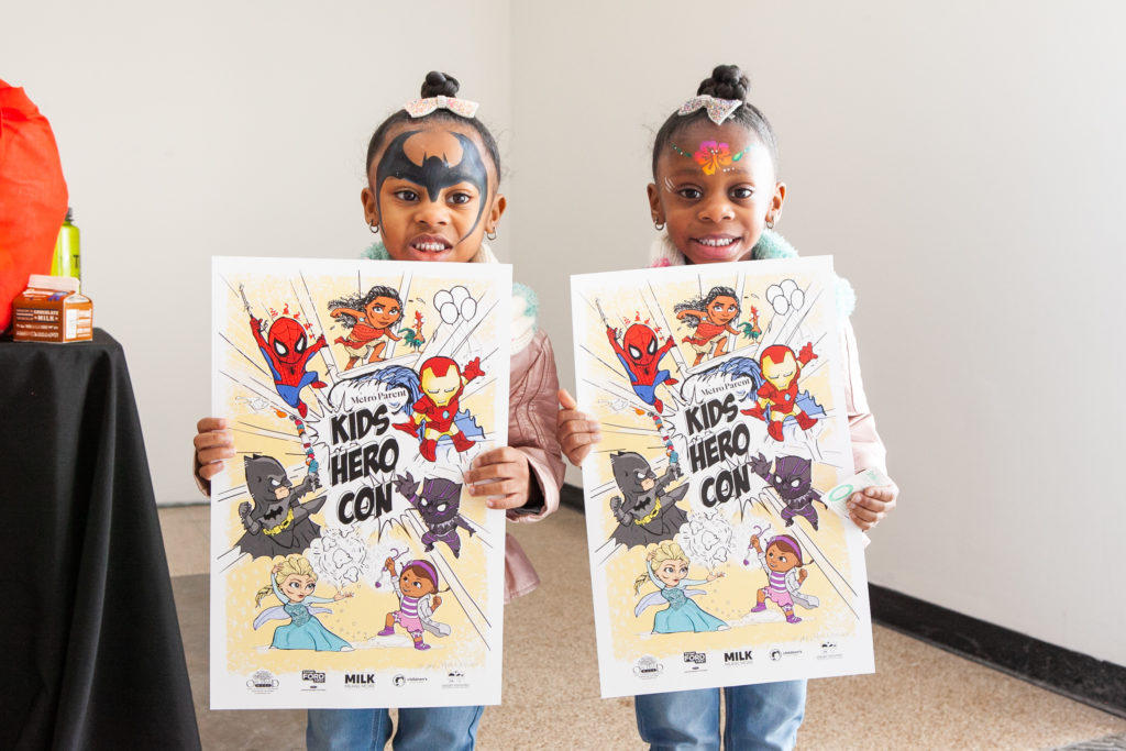 Two kids holding posters