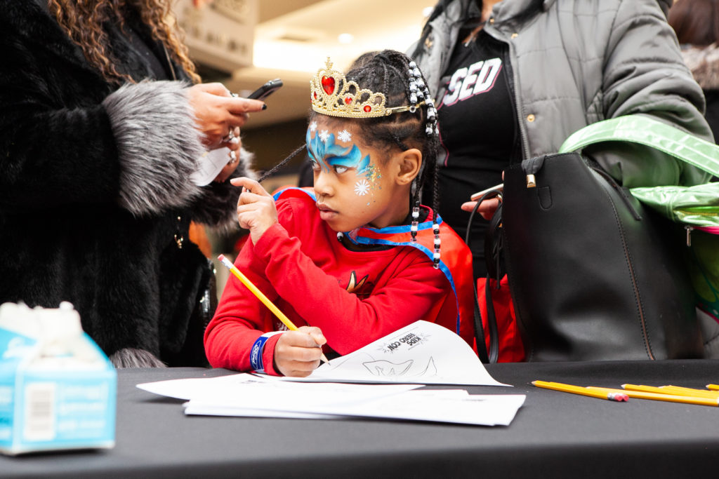 Child at Superhero drawing table