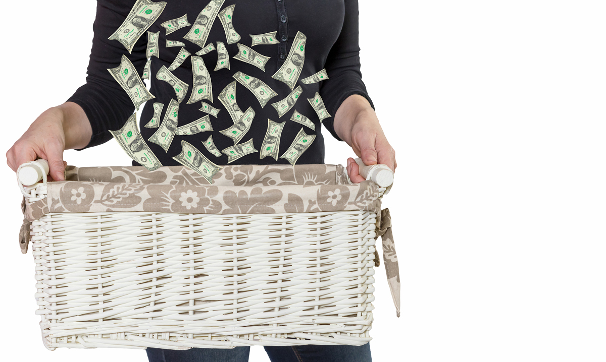 Woman holding a basket with money falling into it