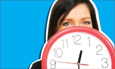 teen peers from behind red clock 