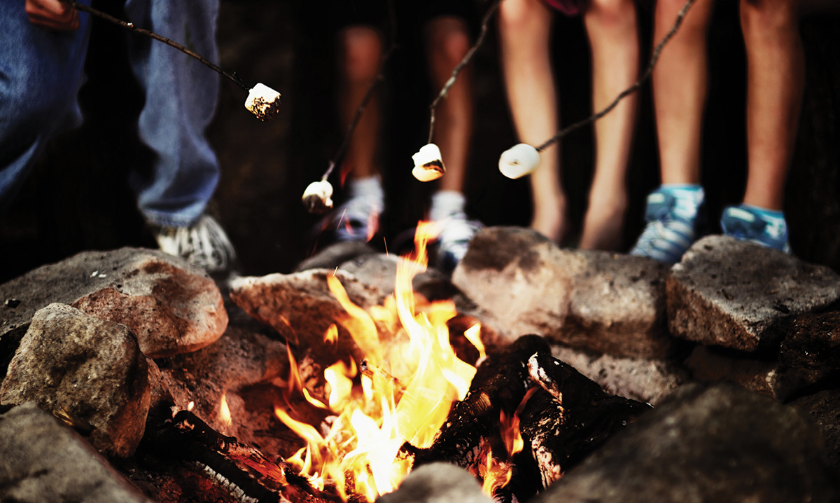 Kids roasting marshmallows over a campfire