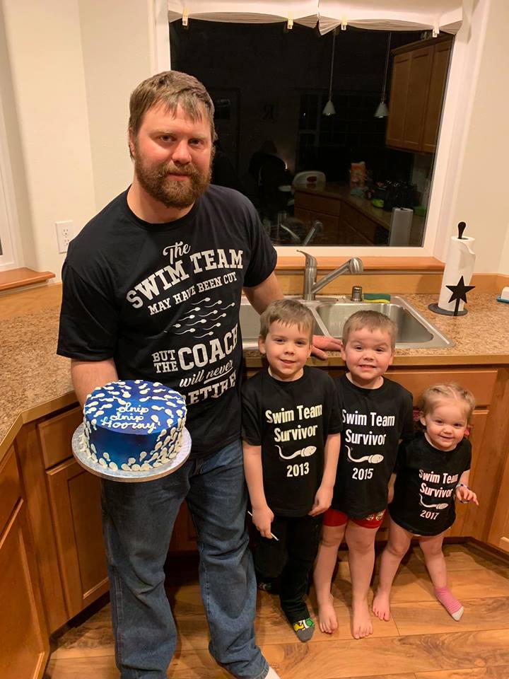 Man stands with children while holding a 'retiring the swim team' cake