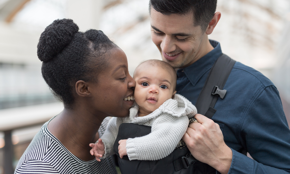 A young mom and dad with their baby