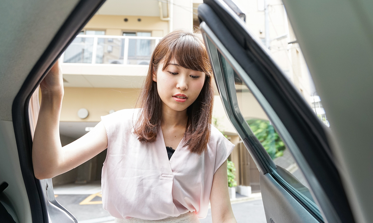 Young girl getting into a car
