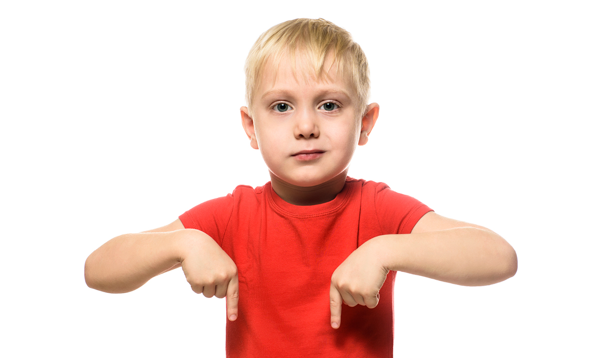 Boy in red shirt pointing down