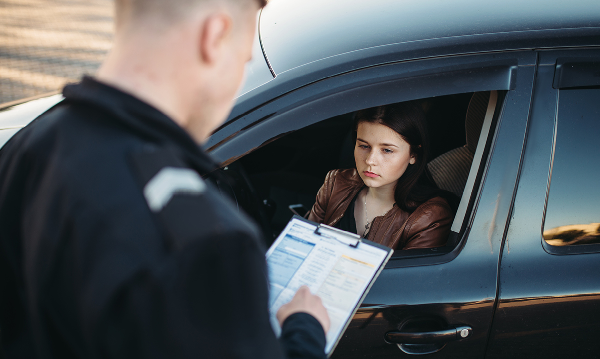 A police officer pulls over a young female teen driver