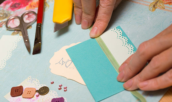 Hands working on a scrapbook