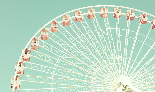 Close-up of a gondola wheel on a greenish-blue background