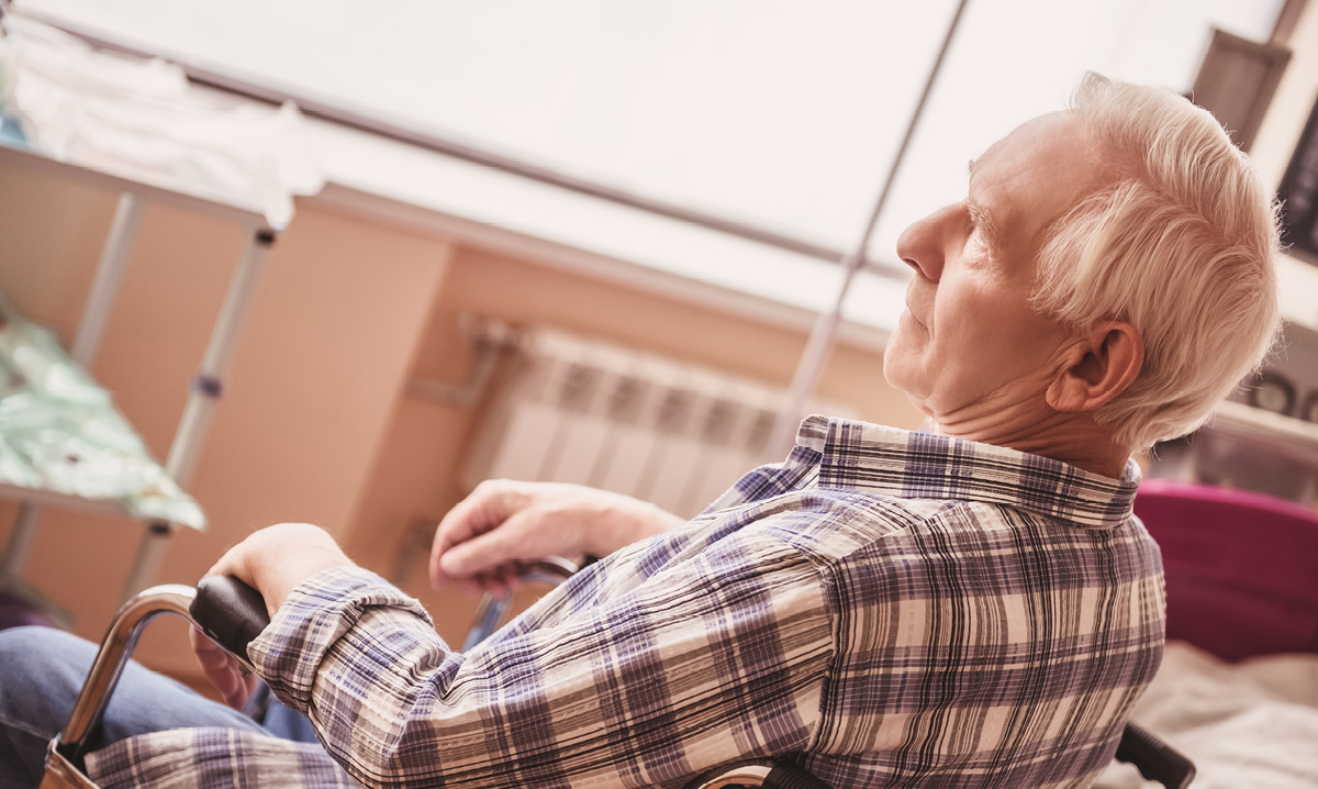 Elderly man in a wheelchair in a nursing home setting