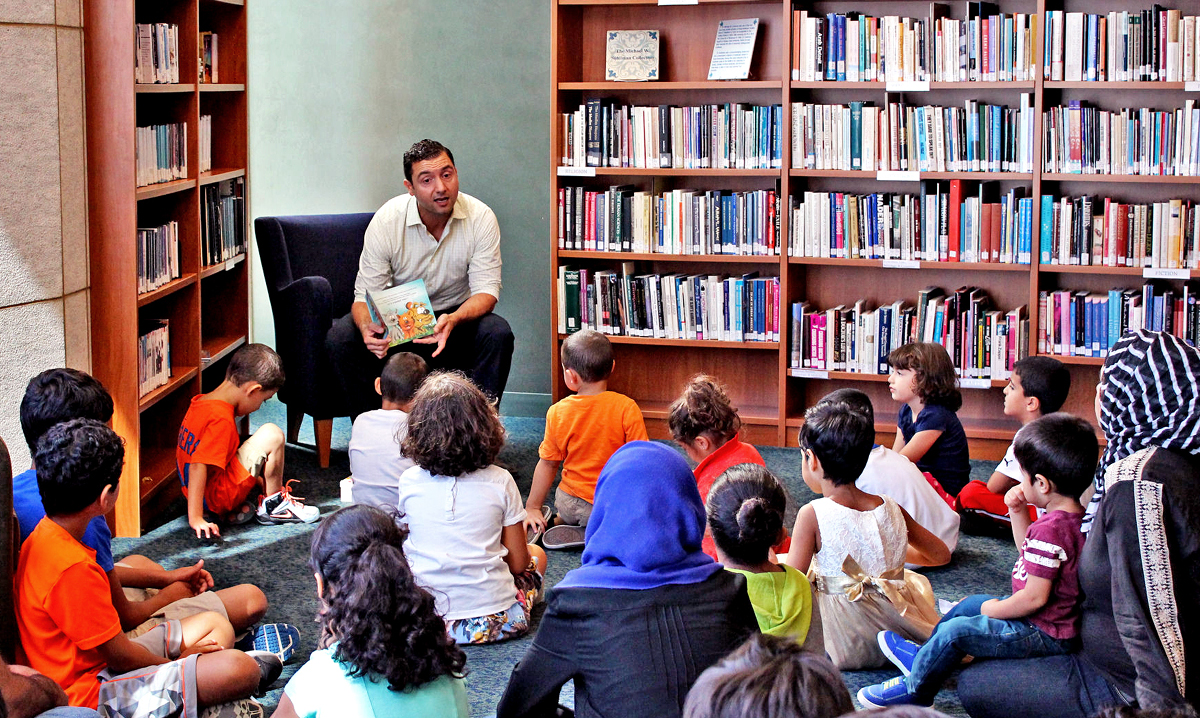 Kids being read to at English-Arabic Storytime