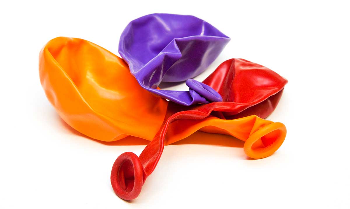 Three deflated unfilled latex balloons