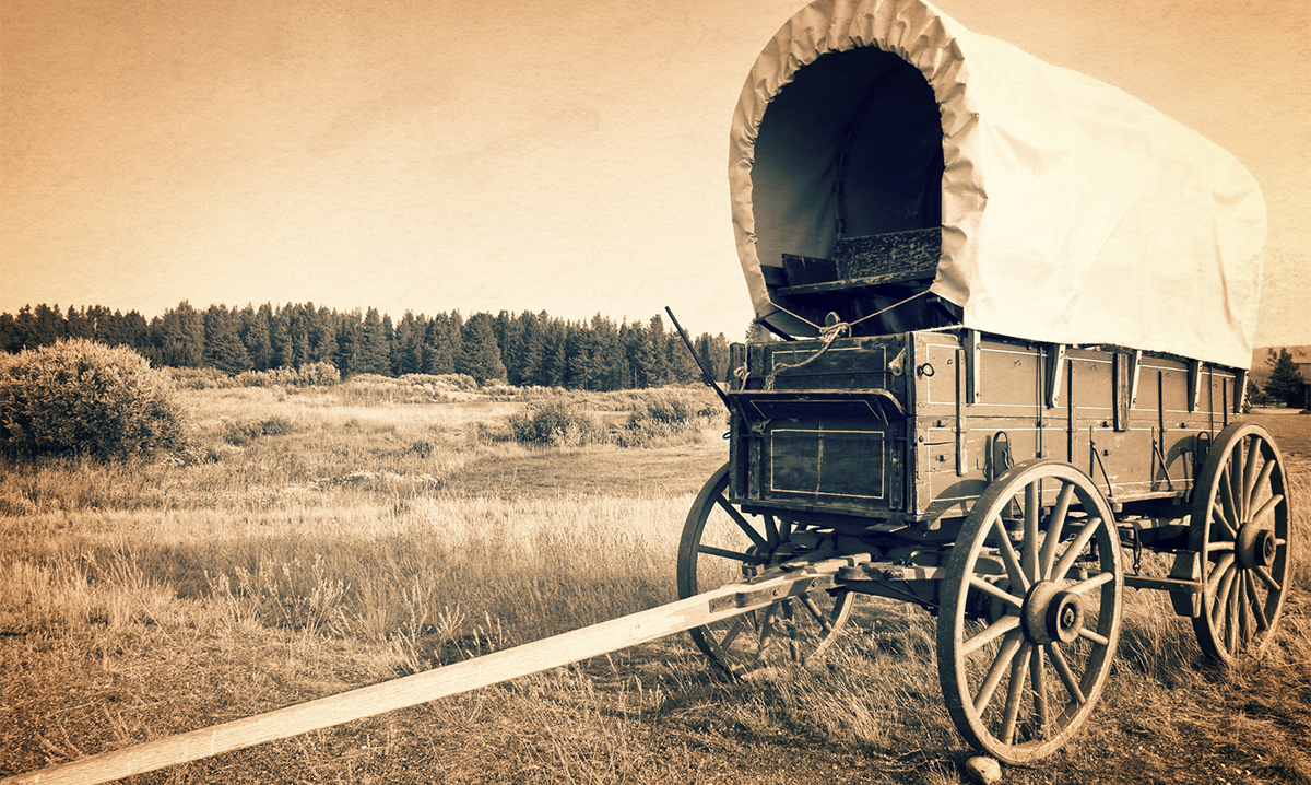 A vintage American western wagon in sepia
