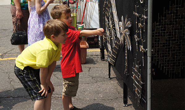 Two children looking at artwork at The Art of Fire in downtown Royal Oak