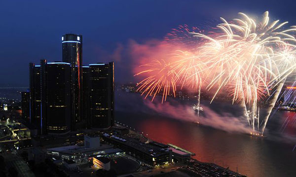 Fireworks going off over the Detroit River near the Ren Cen