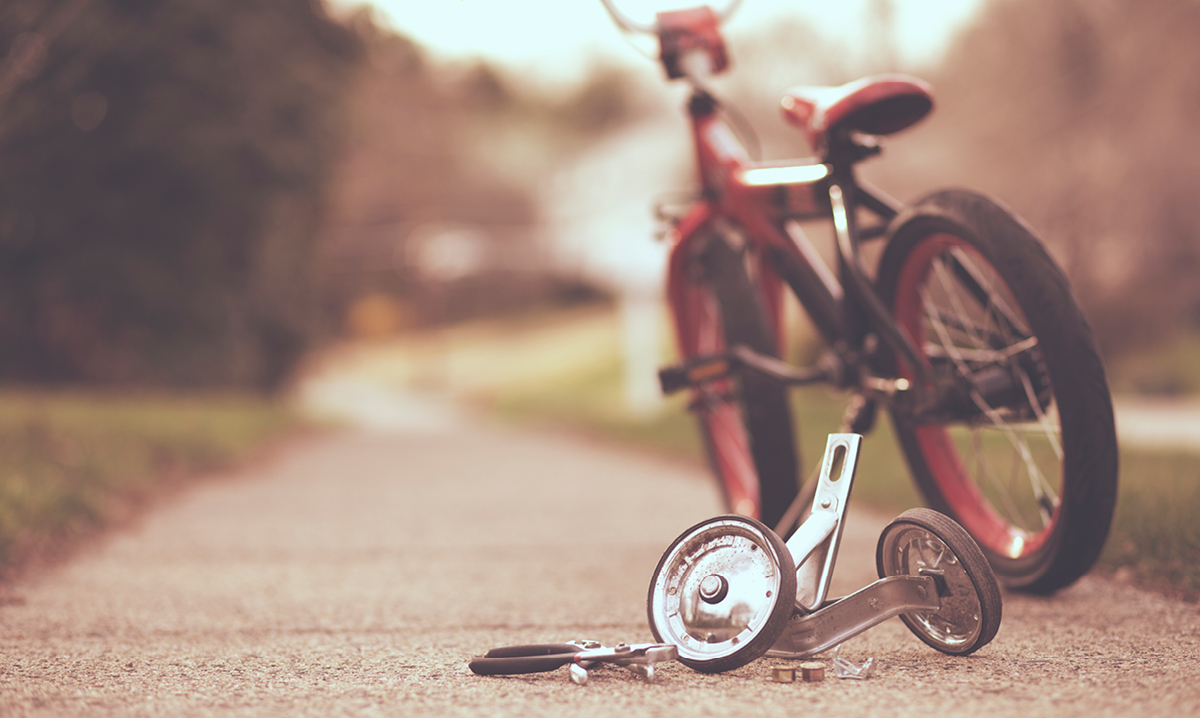 A red bicycle with training wheels removed