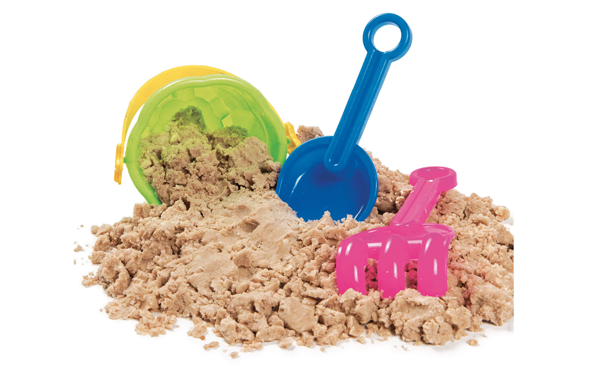 Recipe to Create Edible Kinetic Sand A bucket and shovels in a pile of sand