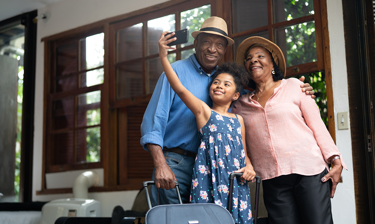 Girl takes selfie with grandparents on vacation