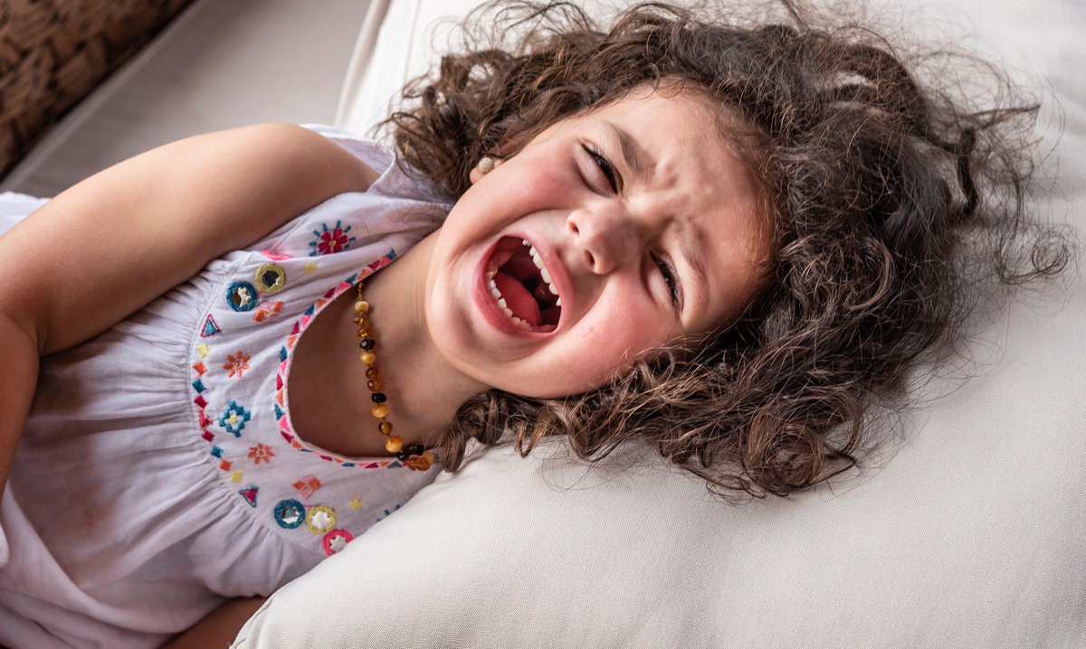 The Wonder Years vs. Testy Toddlers: A Love-Hate Relationship Toddler laying on a bed screaming