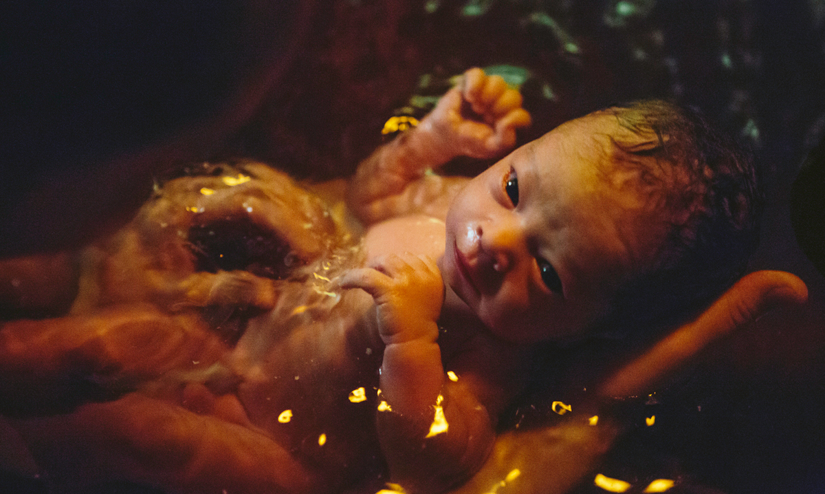 Newborn baby in water