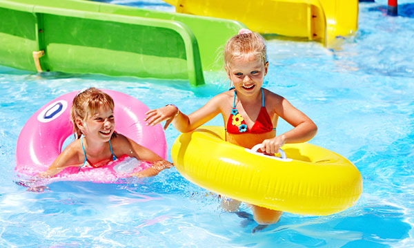 Two girls playing in a public pool