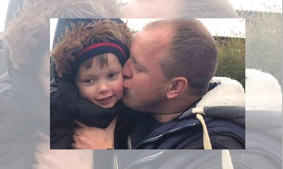Lloyd Jones kissing his son Ollie on the cheek