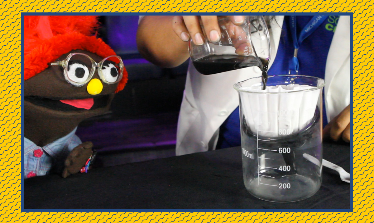 Izzy staring at a beaker