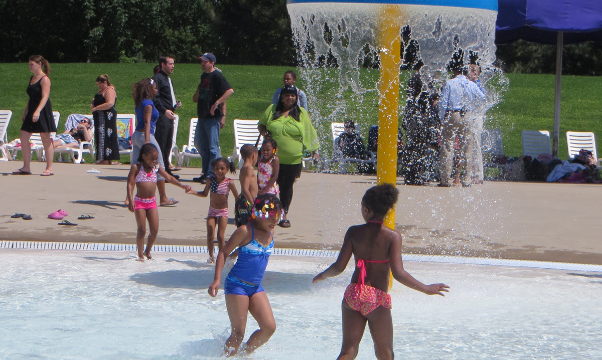 Kids under a splash feature at the Wayne County Family Aquatic Center