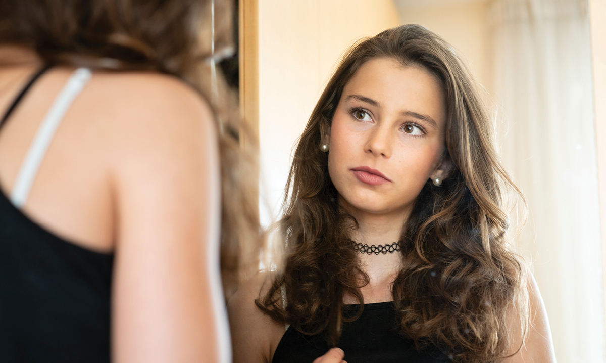 In a Perfect World: Reflections on Girls and Perfection Girl staring into mirror