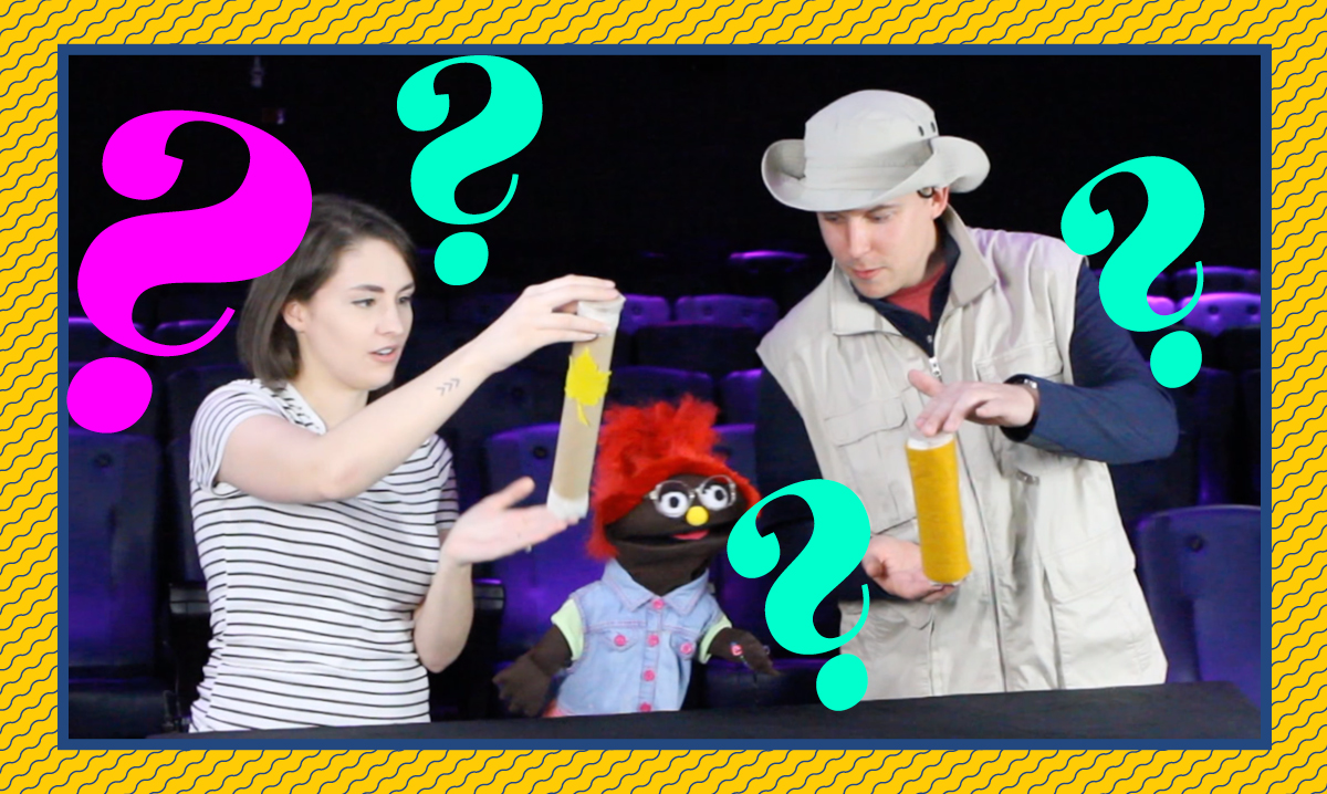 Izzy, Taylor and a friend from the Michigan Science Center making rain sticks surrounded by question marks