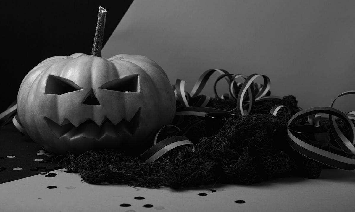black and white photo of a pumpkin surrounded by ribbon