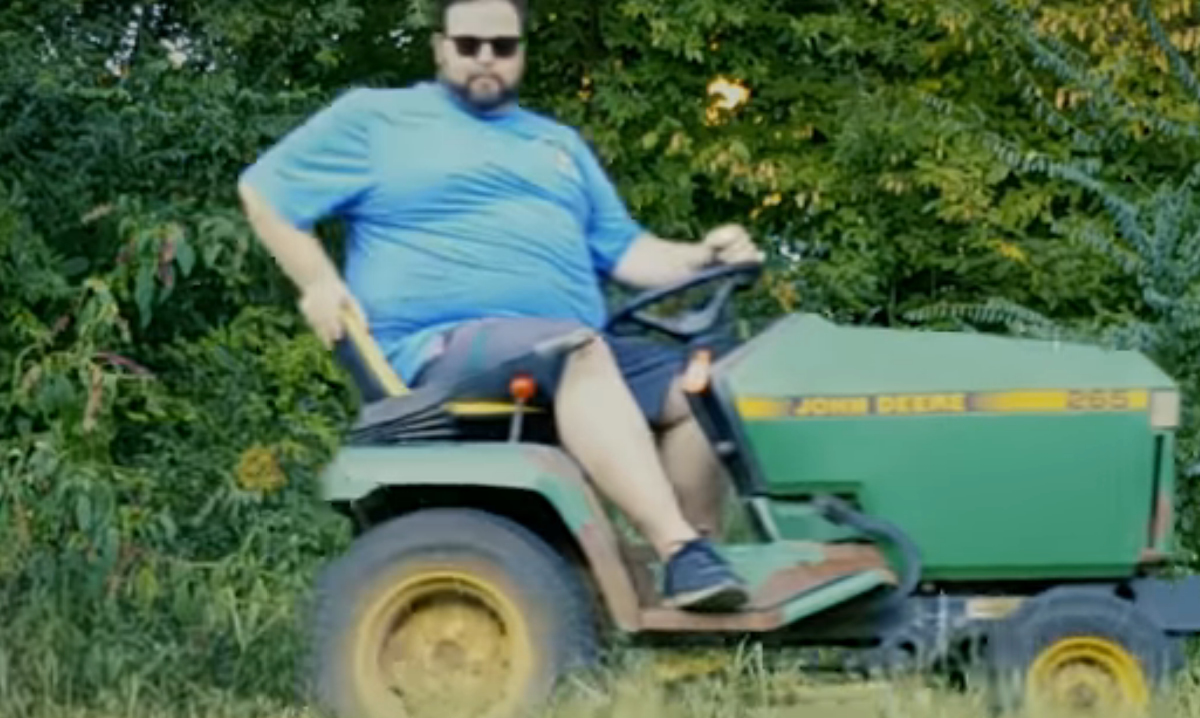 Connor riding a lawnmower