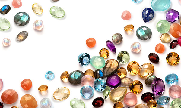 Different color gems on a white background