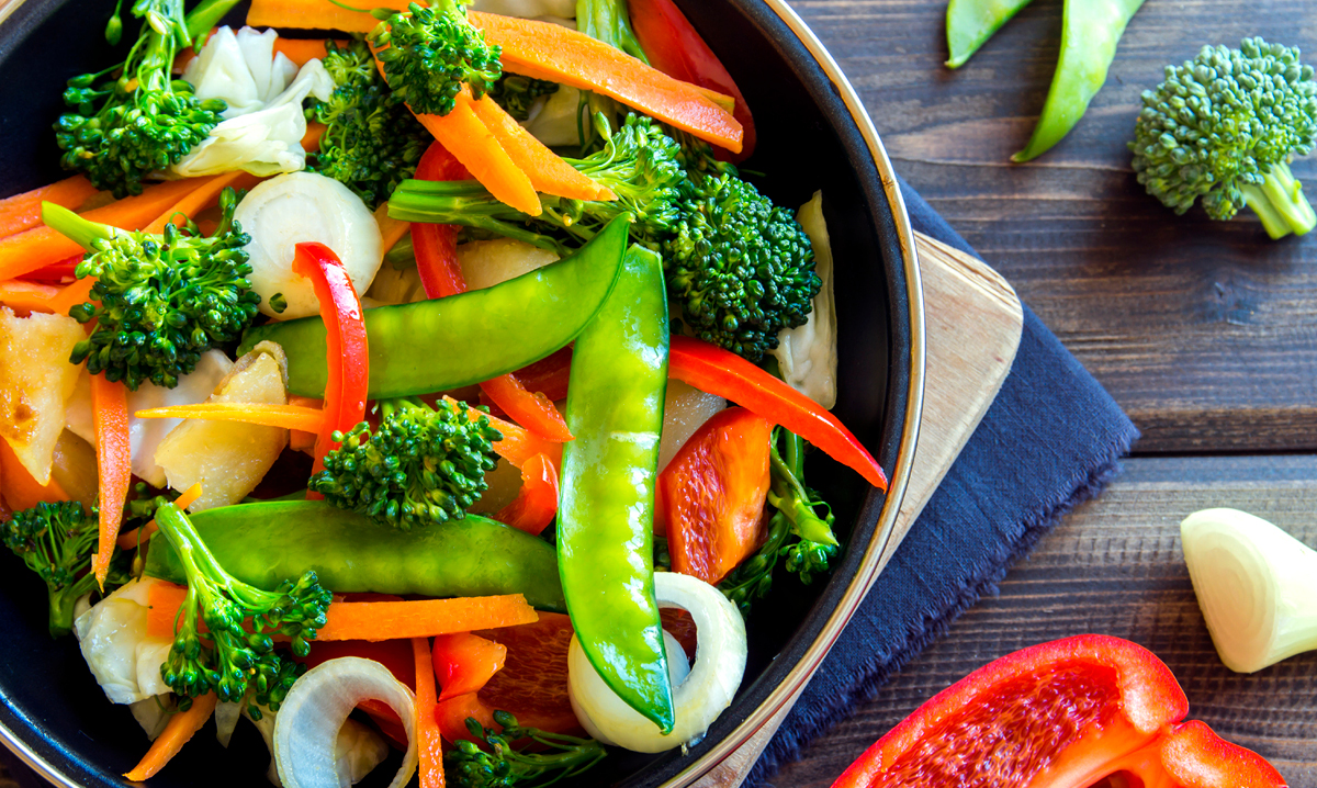 Vegetable stir fry on a wood background