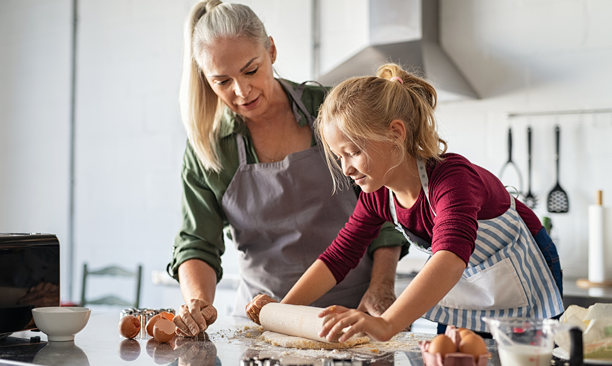 Older woman and child rolling dough