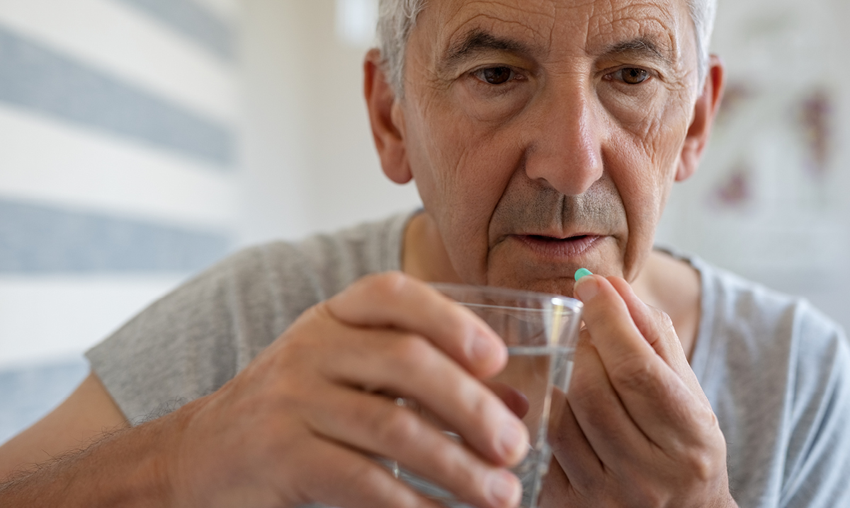 Old man taking pills