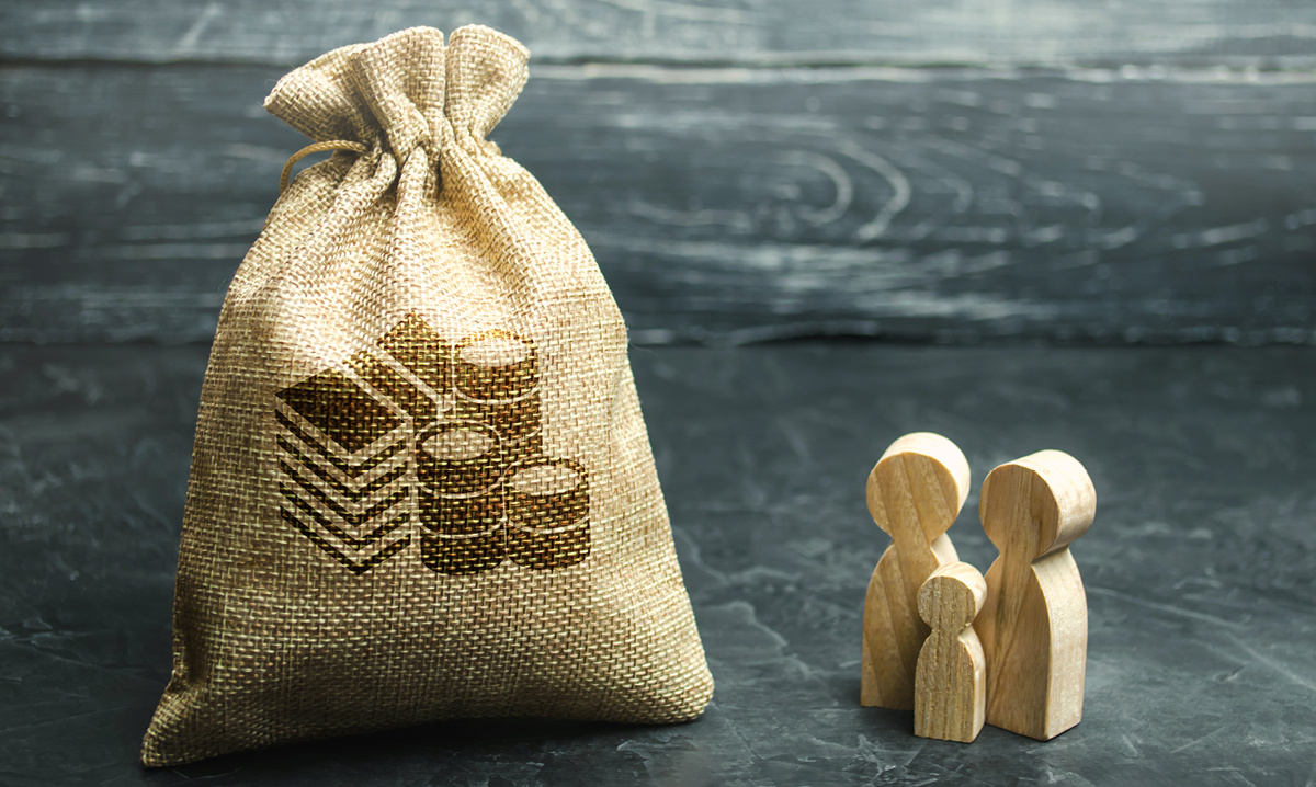 Big sack of money next to small wooden family of three