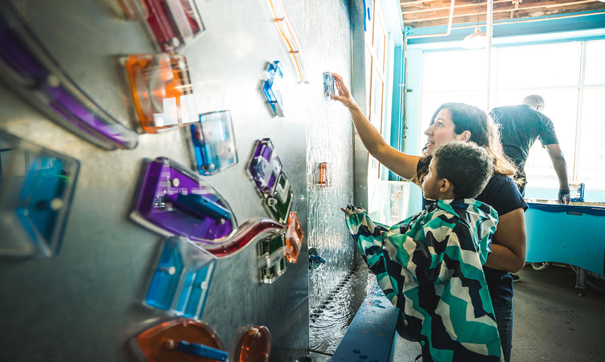 Kids playing on sensory wall