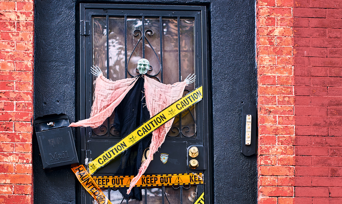 A black door decorated for Halloween