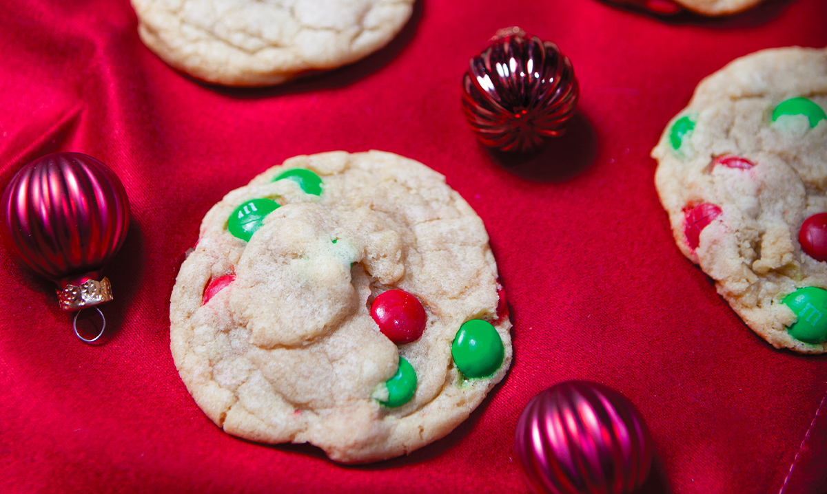 M&M drop cookies on a red background