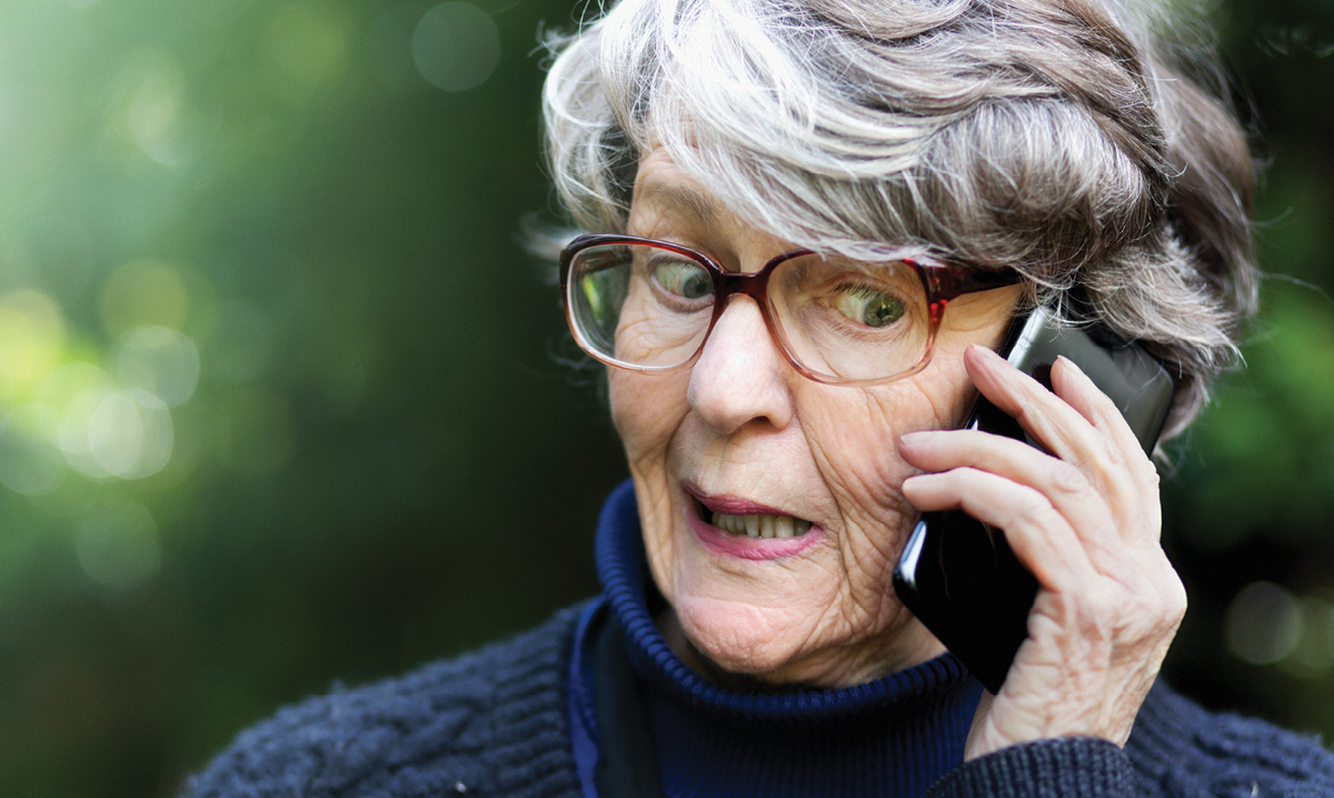 Elderly woman on the phone making a funny face
