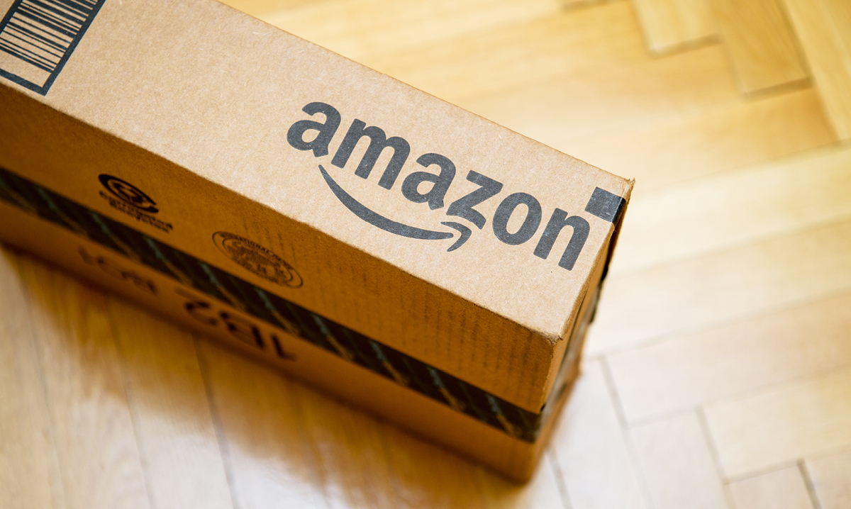 Close up of an Amazon package on a wood floor