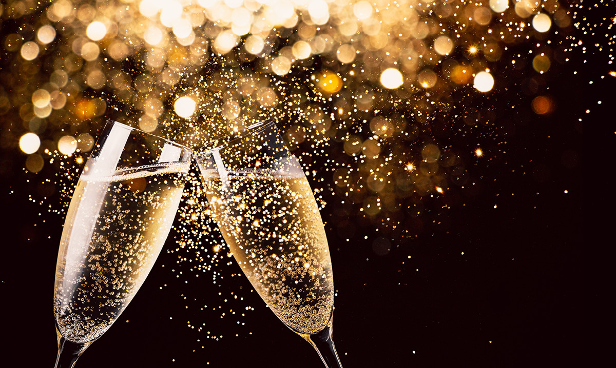 Gold champagne glasses toasting together